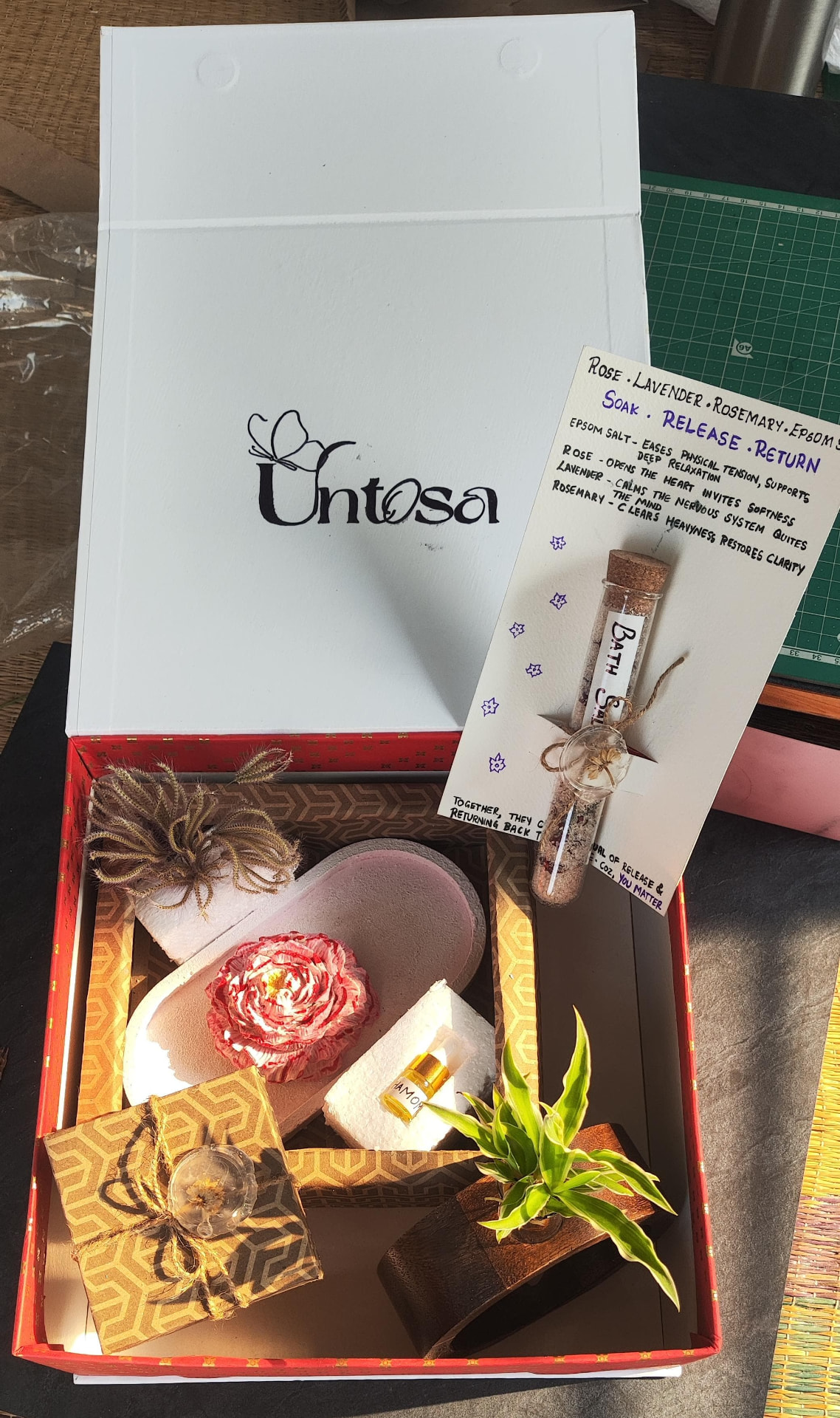 Open Untosa box with slippers, fabric rose, bath salt vial and handwritten ritual card