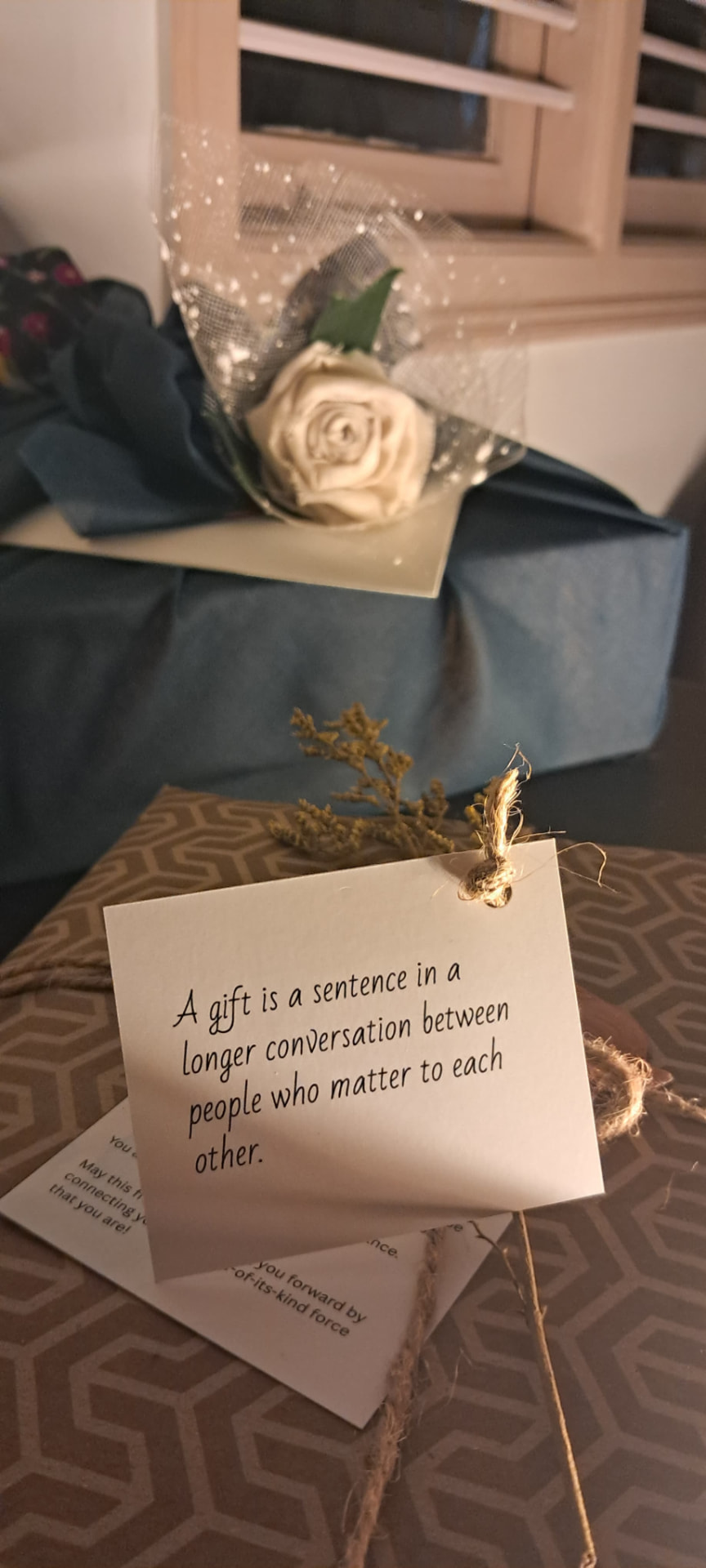 Hand-wrapped Untosa gift with a fabric rose and a handwritten note card